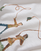 Veronica Beard White graphic t-shirt and blue geometric patchwork jeans.
