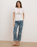 Veronica Beard White t-shirt with graphic print, blue patterned jeans.