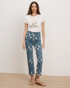 Veronica Beard White graphic t-shirt and blue geometric patchwork jeans.