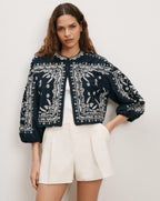 Veronica Beard Black embroidered cropped jacket with white shorts.