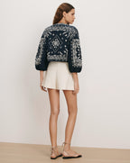 Veronica Beard Navy embroidered blouse, cream shorts, and nude flat
