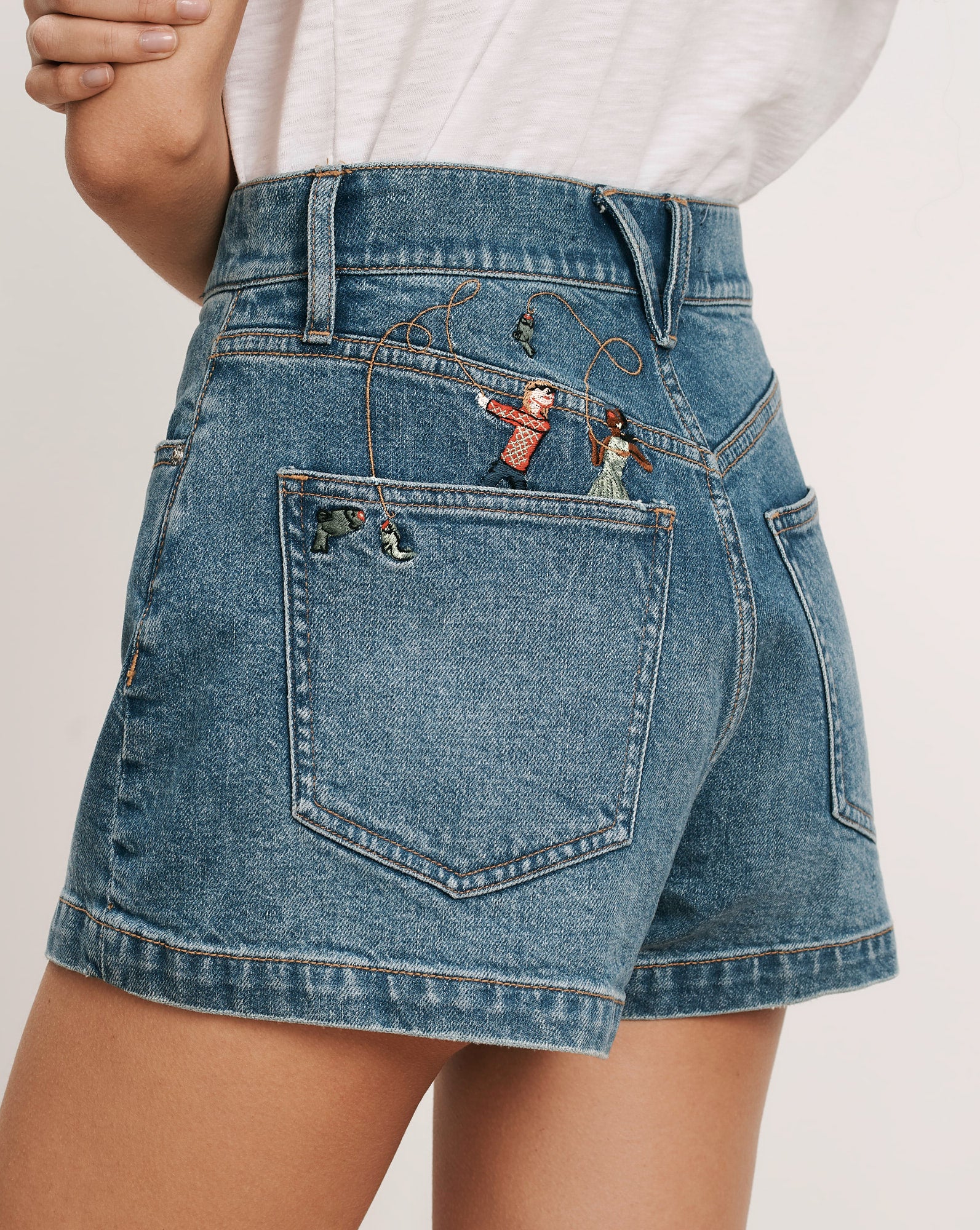 Veronica Beard Blue denim shorts with embroidered figures on the