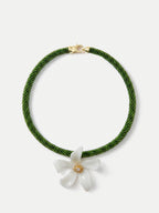 Veronica Beard Green beaded necklace with a white flower pendant.