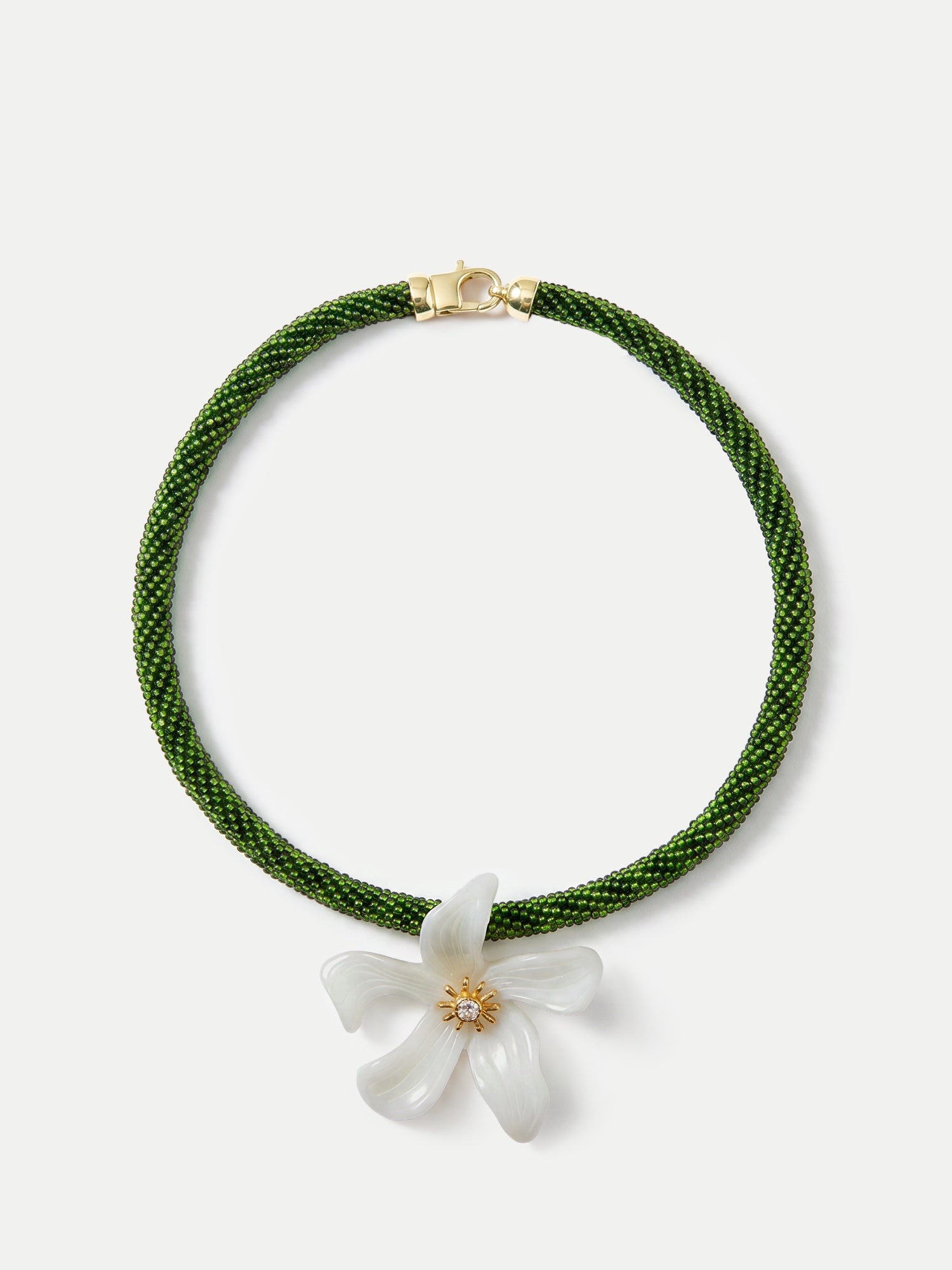 Veronica Beard Green beaded necklace with a white flower pendant.