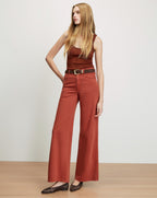 Veronica Beard Brown ribbed tank top, rust wide-leg jeans, and