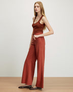 Veronica Beard Brown ribbed tank top and rust wide-leg jeans.