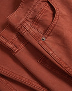 Veronica Beard Brown ribbed tank top, rust wide-leg jeans, and