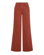 Veronica Beard Brown ribbed tank top, rust wide-leg jeans, and