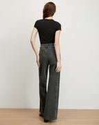 Veronica Beard Black short-sleeve t-shirt and dark gray wide-leg jeans.