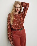 Veronica Beard Brown floral blouse and rust-colored pants with a