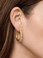 Veronica Beard Gold hoop earring with small white pearls embedded.