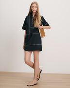 Veronica Beard Black short-sleeved dress with white geometric stitching.