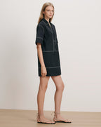 Veronica Beard Black short-sleeved shirt dress with white contrast stitching.