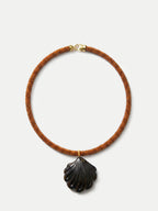 Veronica Beard Brown beaded necklace with a dark shell pendant.