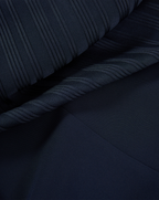 Veronica Beard Navy blue ribbed knit fabric with a smooth section.