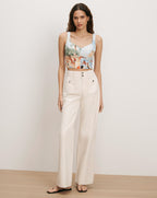 Veronica Beard Printed crop top and off-white wide-leg pants.